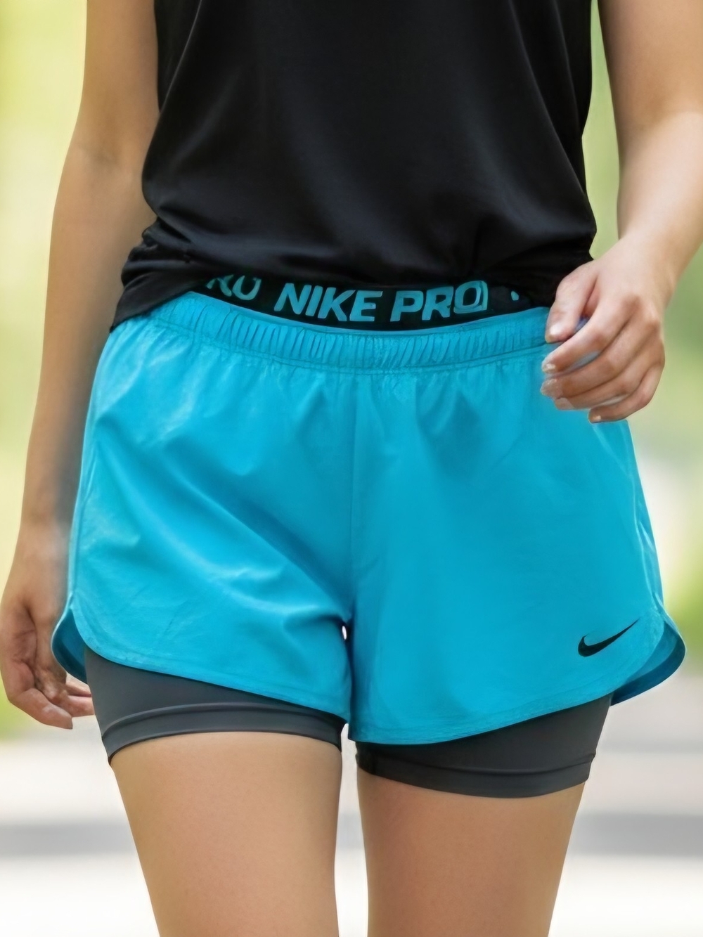 Nike women's 2-in-1 running shorts in a vibrant turquoise blue
